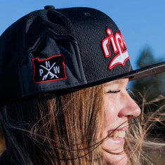 Girl with hair streaming in city cap