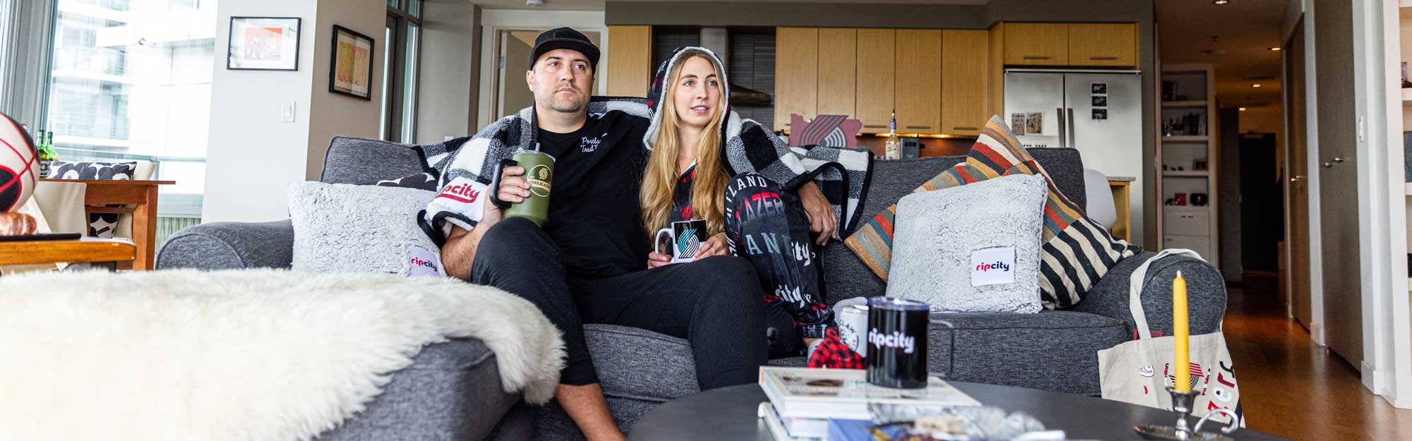 Image of couple in house surrounded by Blazers Gear