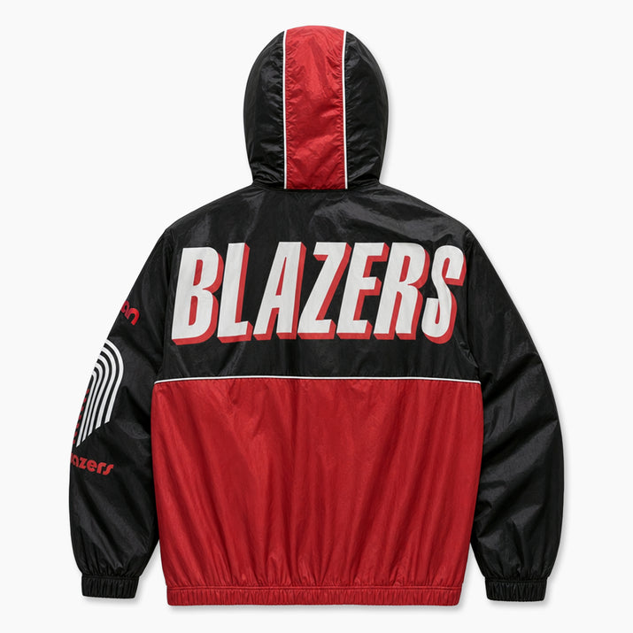 A black and red hooded windbreaker jacket shown from the back, featuring the word 'BLAZERS' in large white letters with a red outline across the upper back. The jacket has a red hood panel, a red lower body panel, and white piping details.