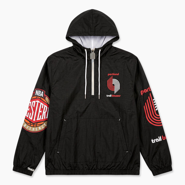 A black hooded windbreaker jacket featuring Portland Trail Blazers graphics, including a large sleeve patch, a red and white chest logo, and 'Trail Blazers' text on the left sleeve, shown against a light gray background.