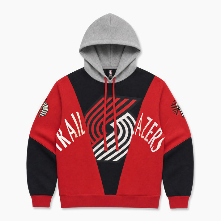 A Portland Trail Blazers colorblock hoodie featuring a red and black body, a gray hood, and white arched 'TRAIL BLAZERS' text across the chest with a large stylized logo in the center.