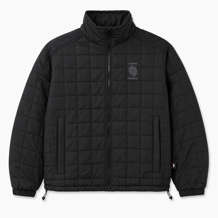 A black quilted zip-up jacket with a stand-up collar, featuring a small gray embroidered logo on the left chest and a small red-and-white tag near the lower sleeve cuff, shown against a plain light gray background.