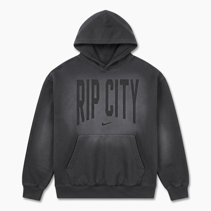 A dark gray washed pullover hoodie with 'RIP CITY' printed in arched block letters and a small Nike swoosh underneath, displayed on a clean white background.