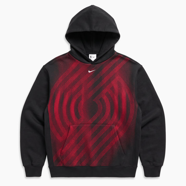 A black Nike pullover hoodie with a red and black diagonal striped graphic pattern across the chest, featuring a small white Nike swoosh logo on the upper chest.