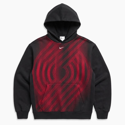 A black Nike pullover hoodie with a red and black diagonal striped graphic pattern across the chest, featuring a small white Nike swoosh logo on the upper chest.