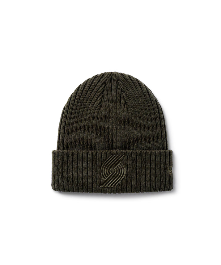 An olive green ribbed knit beanie hat featuring a tonal embroidered logo on the front cuff, set against a plain white background.